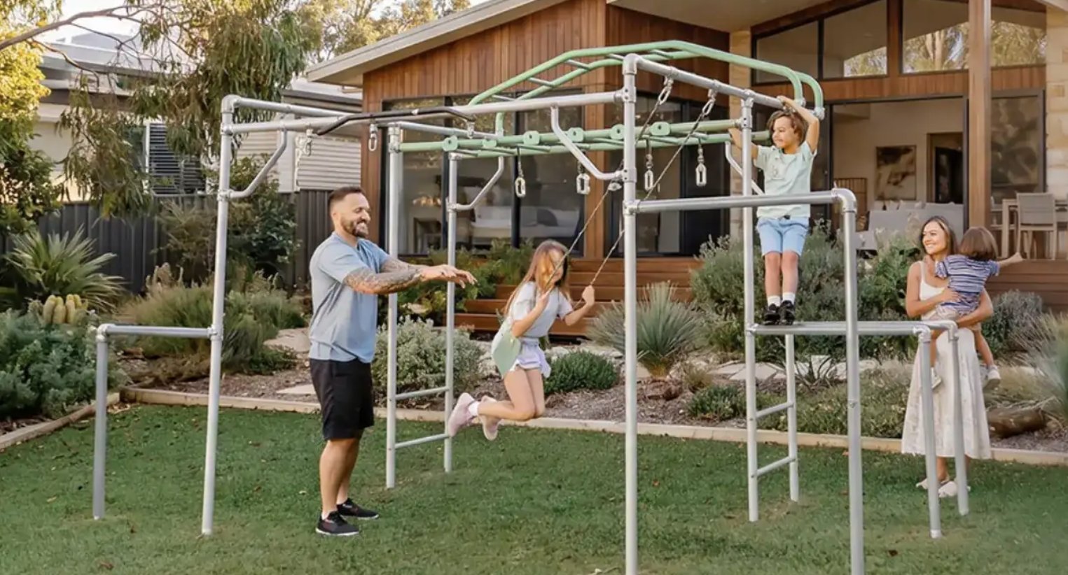 A family playing on a Growplay monkey bar frame in a Perth backyard